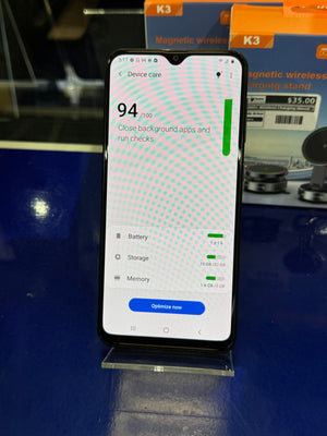 Smartphone showing battery health on a stand