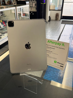Silver Apple iPad Pro on display with an Afterpay sign in a store setting