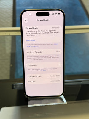 Smartphone displaying battery health information on a stand with a blurred background