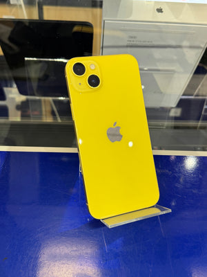 Yellow phone with Apple logo on a blue surface
