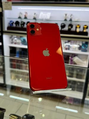Red smartphone with Apple logo on a reflective surface