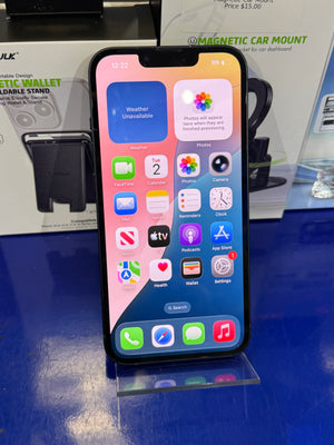 Smartphone with app icons displayed on a reflective surface with blurred background