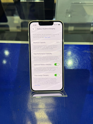 Smartphone displaying a settings screen on a blue surface