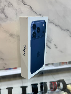 A boxed Apple iPhone shown standing upright, with the white retail box featuring a blue smartphone printed on the front. The Apple logo and the word iPhone are visible.