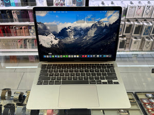 Laptop on display in a store with shelves in the background