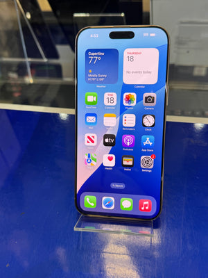 Smartphone with app icons displayed on a reflective surface