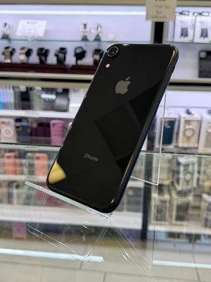 Black smartphone with Apple logo on a reflective surface