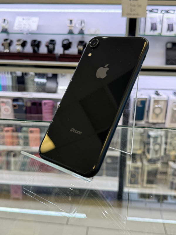 Black smartphone with Apple logo on a reflective surface