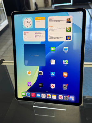 Tablet displaying a grid of app icons on a blue background