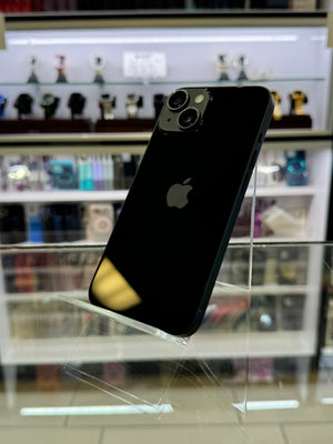 Black smartphone with a clear protective case on a blurred store shelf background