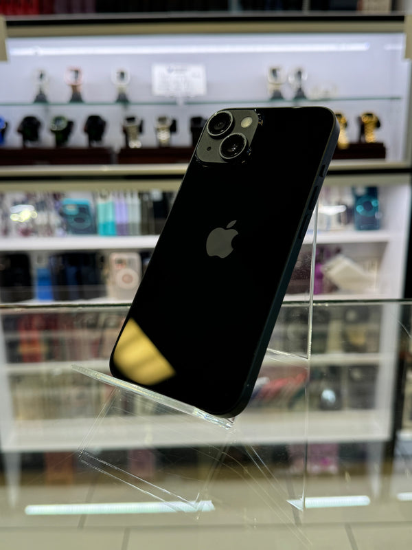Black smartphone with a clear protective case on a blurred store shelf background