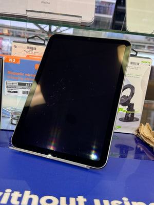 Black tablet with a reflective screen on a blue surface
