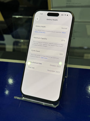 Smartphone displaying a settings menu on a reflective surface