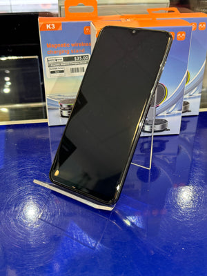 Smartphone on a blue surface with packaging in the background