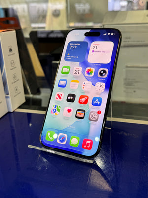 Smartphone with app icons displayed on a reflective surface