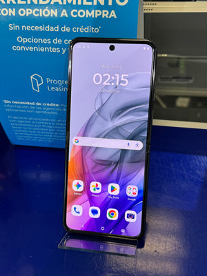 A black smartphone with a colorful purple and orange wallpaper, standing upright on a clear acrylic display stand. 