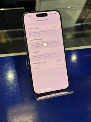 Smartphone displaying battery health information on a reflective surface