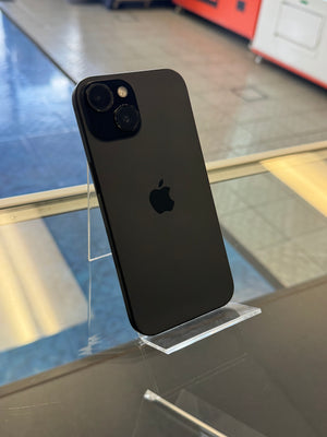 Black Apple smartphone displaying the logo on a clear acrylic stand displayed in a store setting