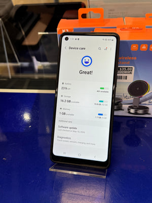 Smartphone on a stand displaying battery health on the screen.