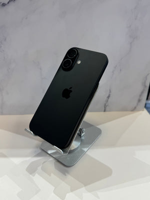 A black Apple iPhone with a dual-camera setup, displayed on a silver stand against a light gray marble-patterned background.