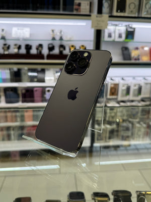 Smartphone with Apple logo on a reflective surface in a store setting