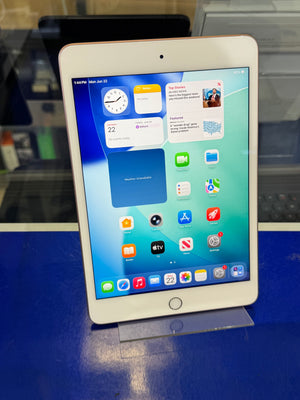 Tablet device with a colorful display on a blue surface