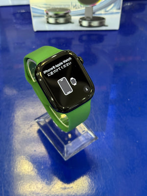 Smartwatch with a green band on a blue surface