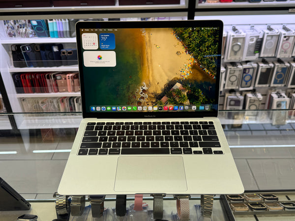 Laptop on display in a store with shelves in the background