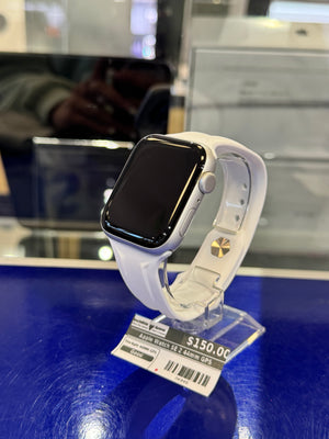 Smartwatch with a white band on display with a price tag in the background