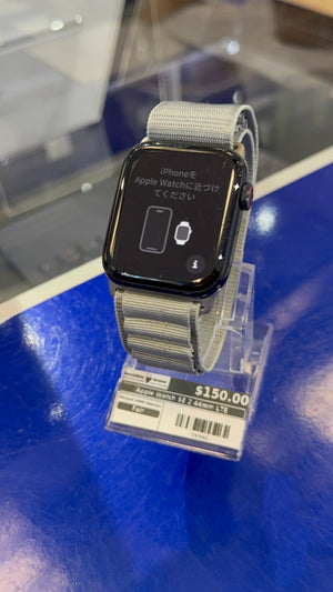 Smartwatch with a gray band on a blue surface, price tag visible