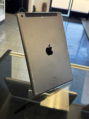 Back view of an Apple iPad on a reflective surface