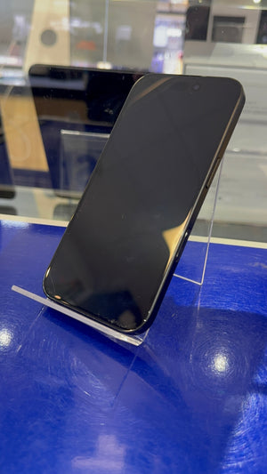 Black smartphone on a stand with a blue surface and blurred background