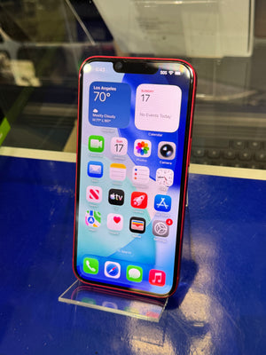 Smartphone with app icons displayed on a blue surface
