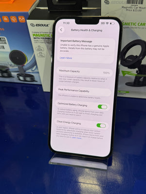 Smartphone displaying battery health information on a blue surface with blurred background