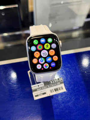 Smartwatch with app icons displayed on a blue surface