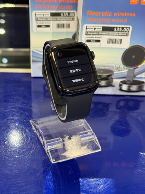 Apple Smartwatch with a magnetic wireless charging stand in the  background