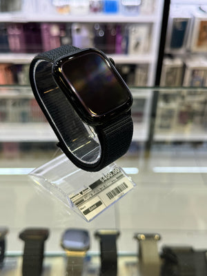 Smartwatch with a black band on a glass surface in a store setting