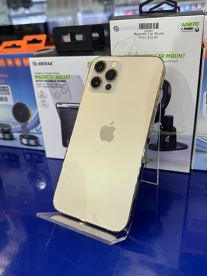 Gold smartphone with Apple logo on a blue surface with packaging and accessories.