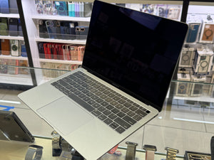 Laptop on display in a store with shelves in the background