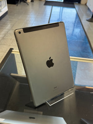 Silver iPad on a stand with Apple logo in an indoor setting