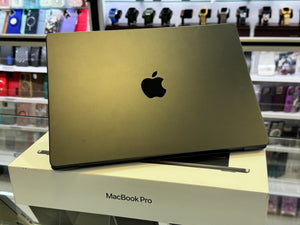 Gold MacBook Pro on a box with blurred store background