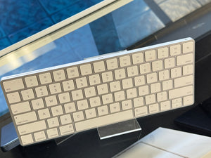 Beige keyboard on a stand with a blurred background