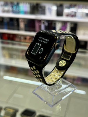 Smartwatch with a black band on a stand against a blurred background