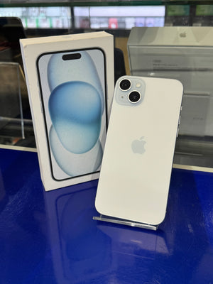 White Apple smartphone on top of its packaging box with a blurred background