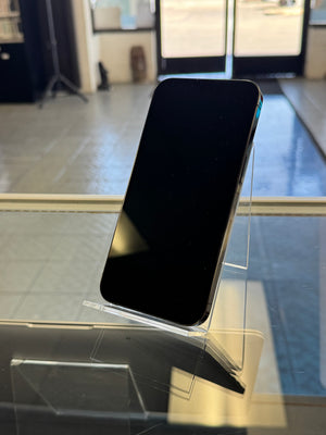 Smartphone held at a diagonal angle with a blurred indoor background