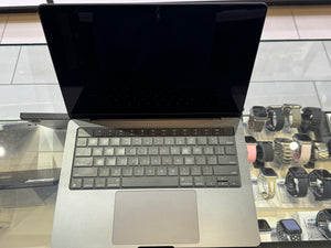 Laptop on a glass table with a reflective surface