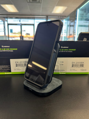 A black 20W QC 3.0 fast charging car charger dock by GOUZAK stands on a dark surface in front of its product packaging boxes.