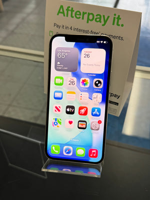 Smartphone displaying a colorful app interface with an Afterpay promotional box in the background.