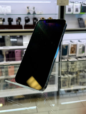 Smartphone held up to a glass window with reflections visible