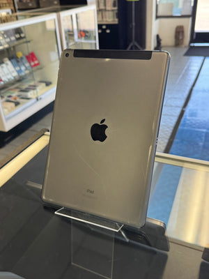 Silver Apple product on display with a blurred store interior background